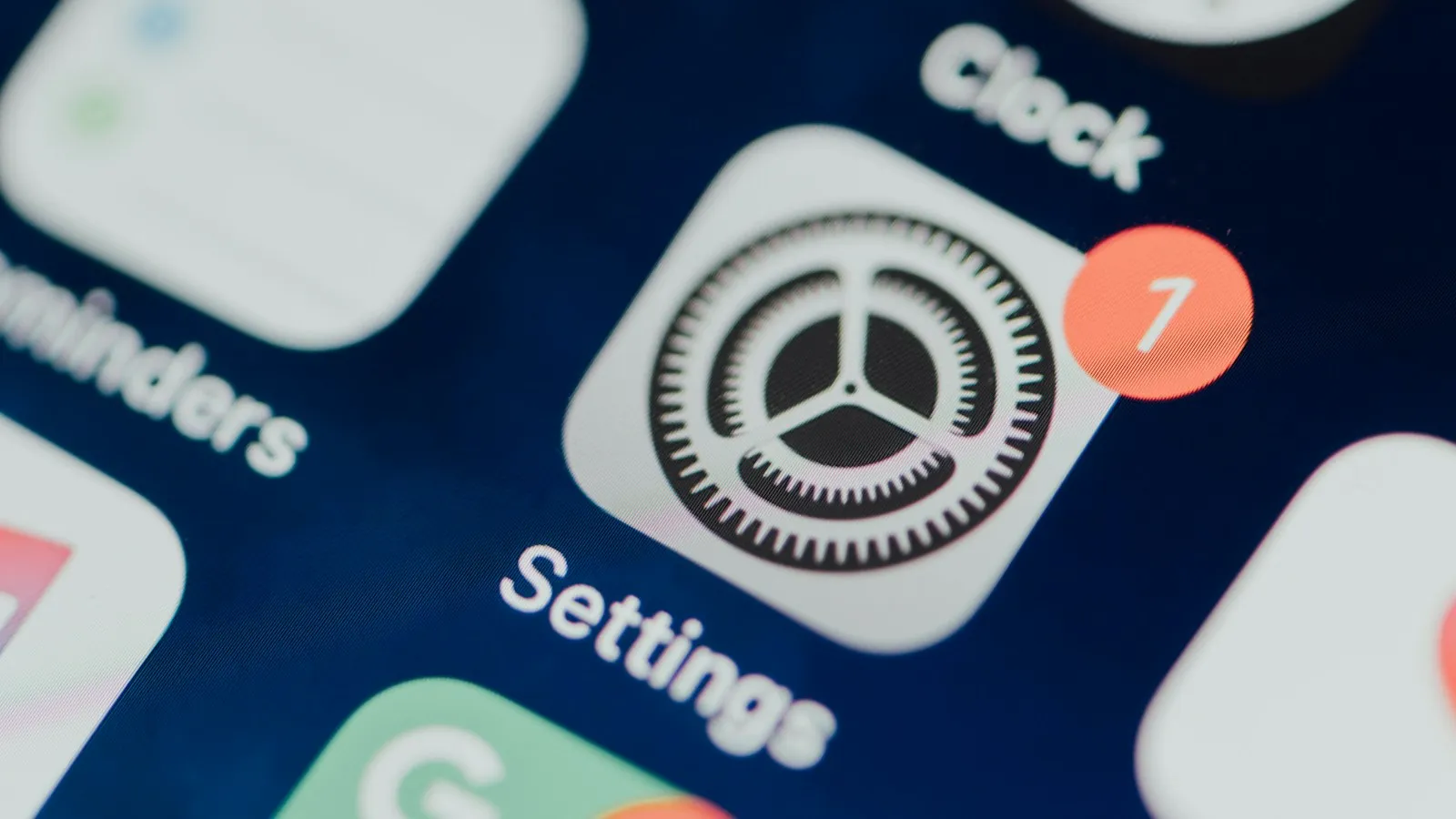 iPhone home screen with a Settings app icon showing a red badge