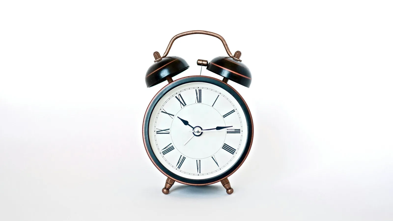 Classic twin-bell alarm clock on a white background